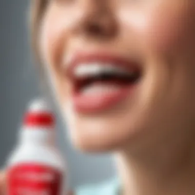 Person using Colgate Plax mouthwash