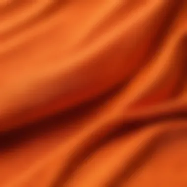 Close-up of fabric texture and stitching on an orange t-shirt