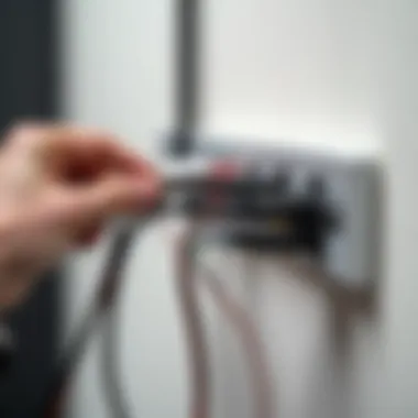 Installation of wire clips along a wall to organize cables